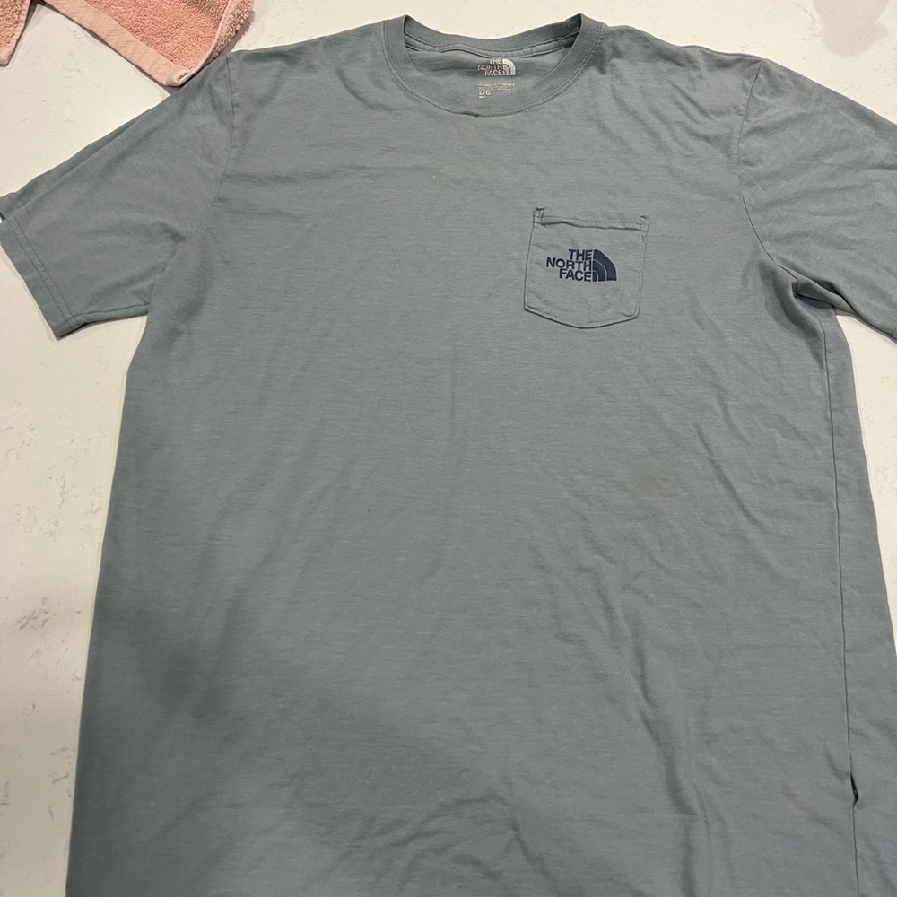LIGHT BLUE NORTH FACE FRONT POCKET TEE SHIRT